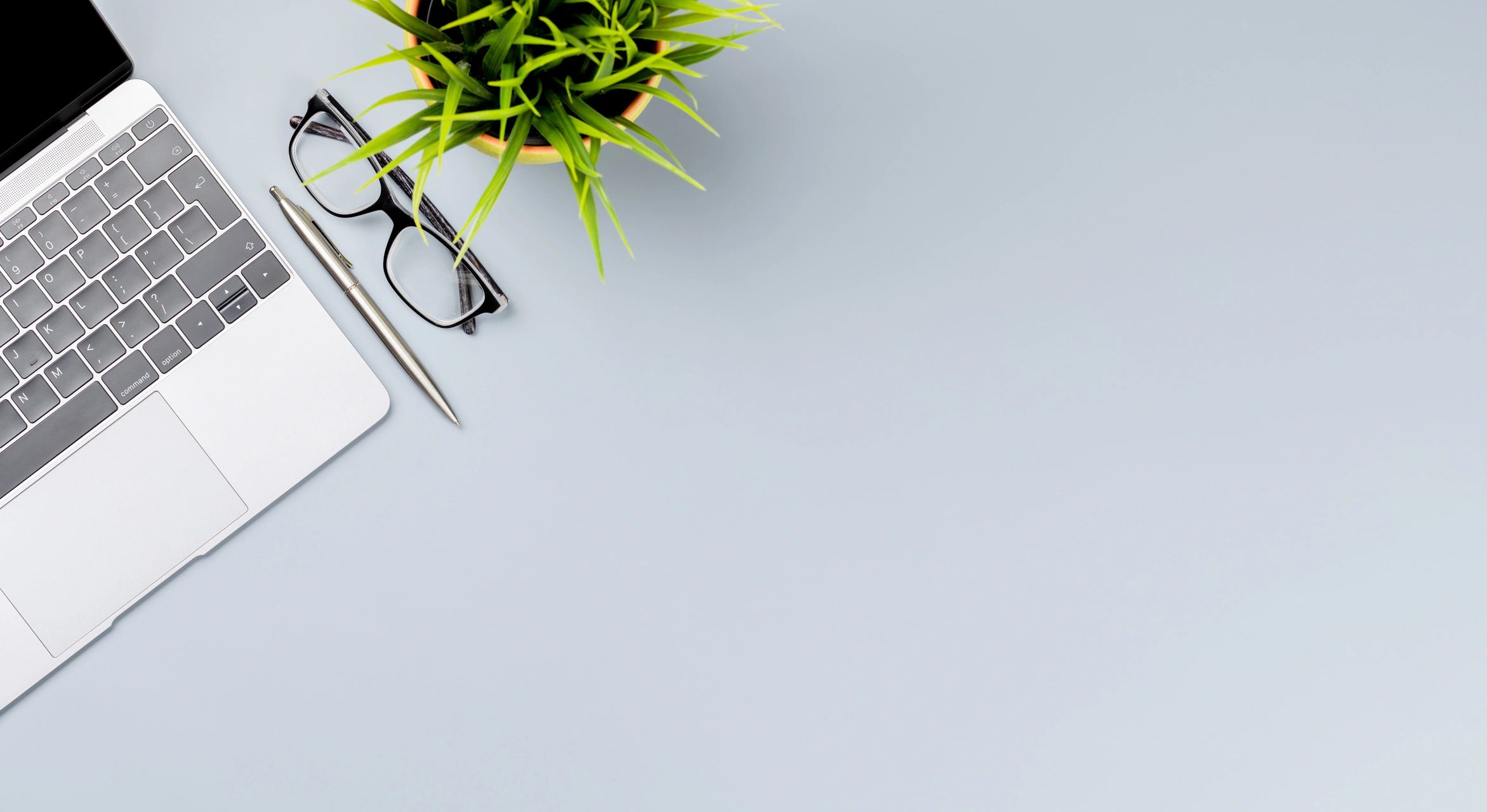 Workspace with laptop and planning materials for communications strategy